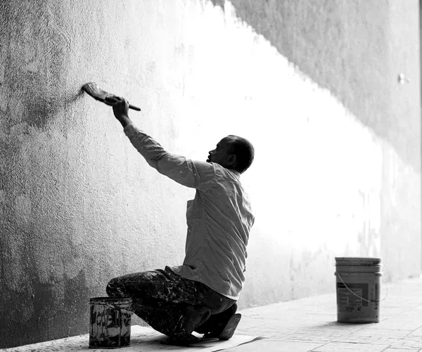 Close-up of a paint roller applying fresh paint