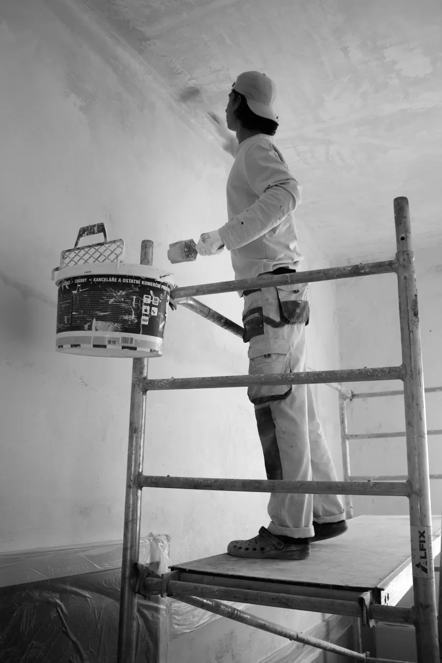 Painter rolling warm colour onto an interior wall