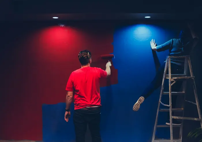 Team painting an interior wall together