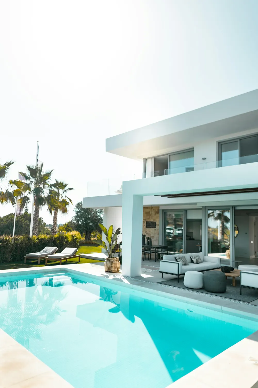 Freshly painted white luxury villa exterior with swimming pool